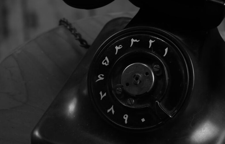 vintage black rotary dial telephone with arabic numerals